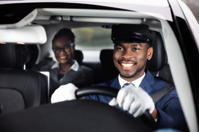 happy man driving his female passenger in a car