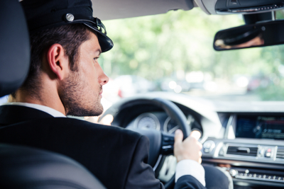 portrait of a handsome male chauffeur riding car